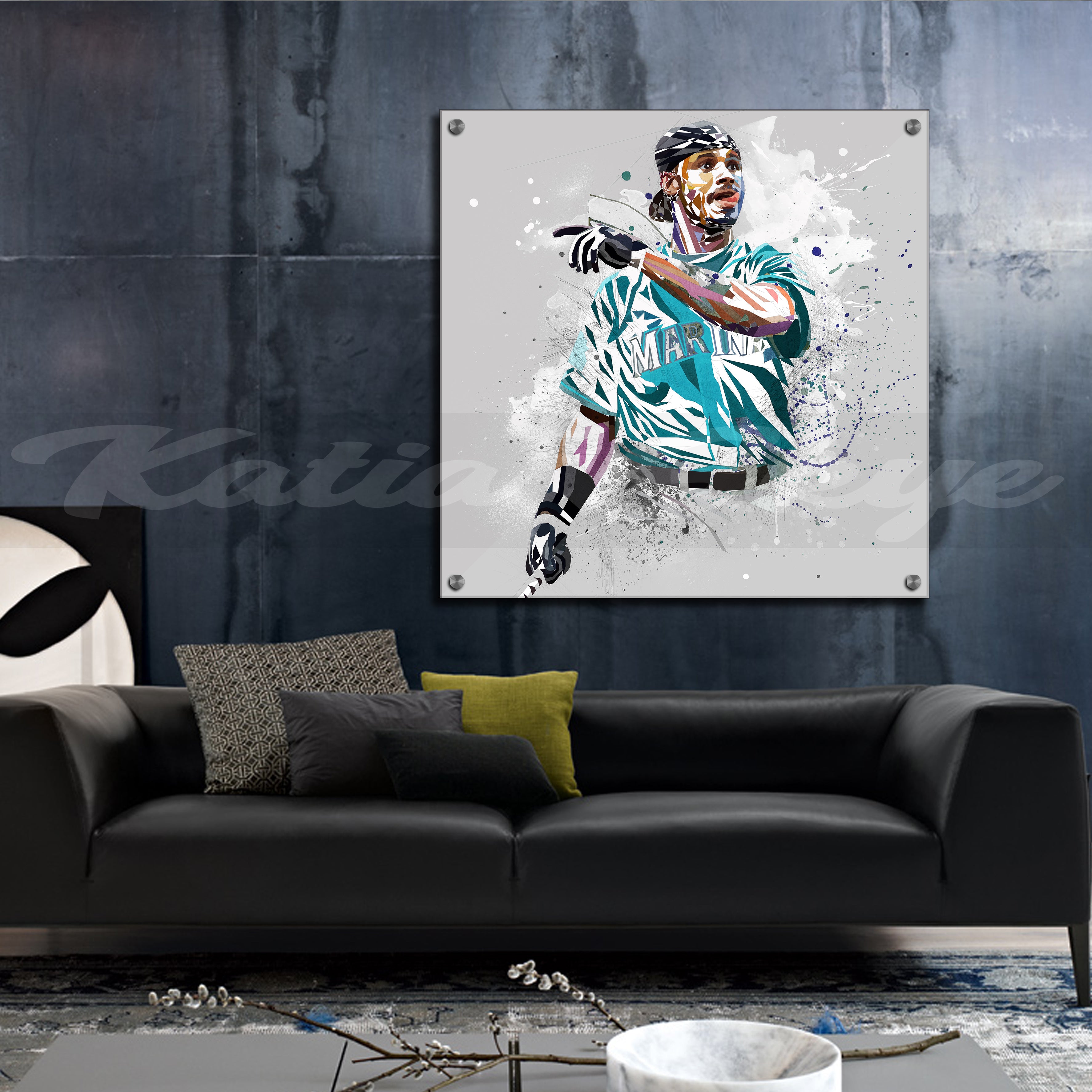 Acrylic print of Ken Griffey Jr in a teal jersey hanging on a wall above a black sofa.